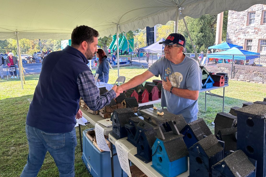 Lawler shakes hands with independent voter Kevin Frank at the Stony Point Fall Festival in New York. Frank is supporting the GOP lawmaker because he says he is frustrated with Democrats.