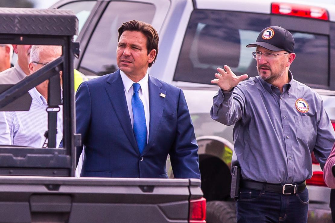 Florida Gov. Ron DeSantis gets a tour from Florida Division of Emergency Management Director Kevin Guthrie while talking about the heavy machinery staging area at the Florida Horse Park in Ocala, Florida, on October 8, 2024, before a press conference about the impact that Hurricane Milton will have on the state of Florida.